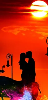 Silhouetted couple kissing at sunset with vibrant orange background.