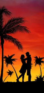 Silhouette of a couple embracing under palm trees against a vibrant orange sunset.