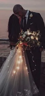 Romantic couple kissing at sunset by the ocean, bride in glowing gown.