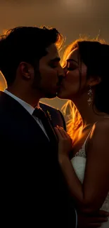 Couple sharing a sunset kiss in warm, romantic lighting.