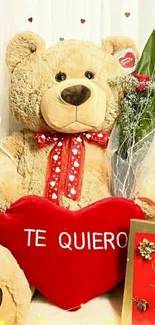 Teddy bear holding red heart saying 'Te Quiero' with gift box.