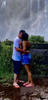 Romantic couple embracing by a waterfall with lush greenery.