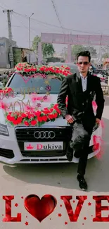 Man in black suit with decorated wedding car and bold LOVE text.