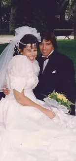 Bride and groom in park, wedding attire, smiling together, lush greenery.