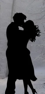 Silhouette of couple in winter forest wallpaper.