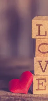 Wooden blocks spelling LOVE with a red heart.