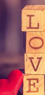 Wooden blocks spelling 'LOVE' with red heart.