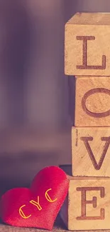 Wallpaper with wooden blocks spelling "LOVE" and a heart accent.