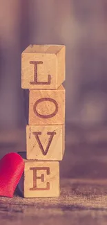 Wooden blocks spelling LOVE with red heart.