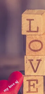 Wooden blocks spelling love with red heart.