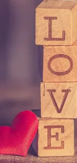 Wooden blocks spelling LOVE with a red heart.