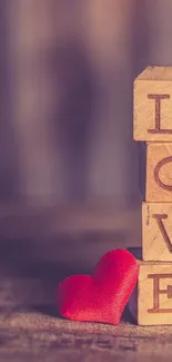 Wooden blocks spelling 'Love' with red heart on rustic background.