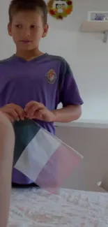 Boy in purple shirt in toy-filled room.