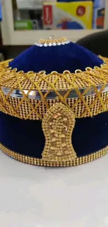 Royal blue and gold crown on a display.