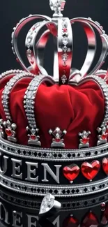 Elegant red and silver jeweled crown on black background.