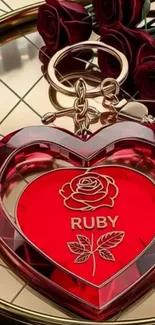Ruby heart keychain with rose emblem on a metallic background.