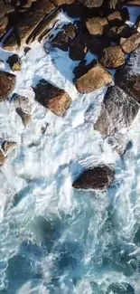 Aerial view of crashing waves against rugged rocks on a coastal shoreline.