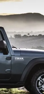 Thar SUV exploring a mountain landscape under a misty sky.