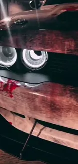 Close-up of a distressed vintage car's front with prominent headlights at night.