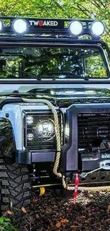 Rugged Land Rover Defender in a forest, perfect for adventure enthusiasts.