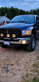 Rugged truck with headlights in a rural setting wallpaper.