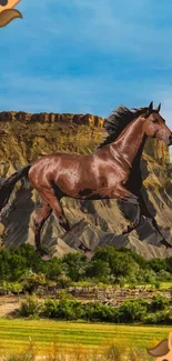 Horse running in front of a mountain with blue sky.