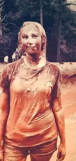 Muddy portrait of a woman in a natural outdoor setting.