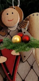 Rustic wooden angel with Christmas ornaments and greenery.