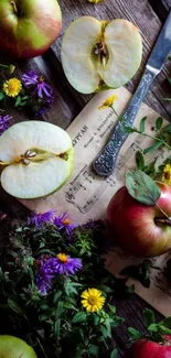 Fresh apples and flowers on rustic wooden background.