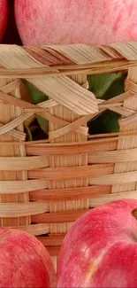 Close-up of pink apples in a woven basket.