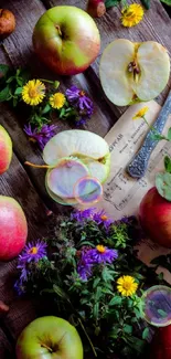 Rustic wooden table with apples and wildflowers in vibrant display.