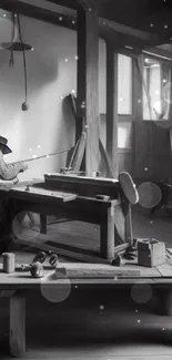 Black-and-white wallpaper of a rustic workshop with an artisan at work.