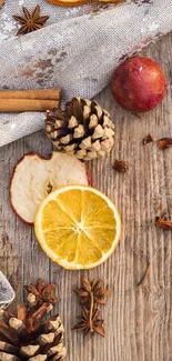 Rustic autumn-themed wallpaper with pinecones and dried citrus on wood.