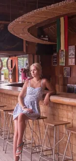 Woman sitting in a rustic bar with wooden decor.