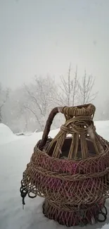 Wicker basket amidst snowy winter landscape, serene and minimalist.