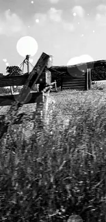 Rustic black and white countryside wallpaper with a wooden fence and open fields.