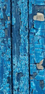 Close-up of rustic blue wood texture with peeling paint on a vertical panel.