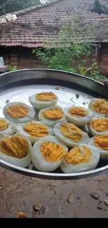 Platter of boiled eggs in a rustic village setting