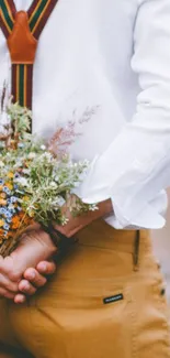 Rustic floral bouquet with suspenders in nature.