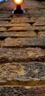 Close-up of rustic brown brick wall with light.