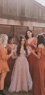 A bridal party in elegant rust dresses gathered outdoors.