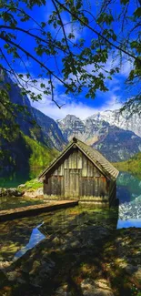 Serene image of a rustic cabin by a mountain lake with blue sky.