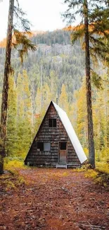 A-frame cabin in autumn forest setting.