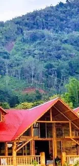 Rustic wooden cabin set against a lush green forest backdrop.