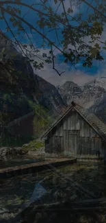 Rustic cabin nestled in scenic mountains with greenery and blue sky.