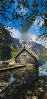 Rustic cabin by a serene mountain lake with lush greenery.