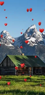 A rustic cabin in a green meadow with mountain backdrop.