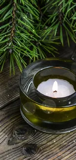 Rustic table with candle and green pine branches.