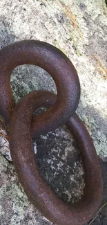 Rustic metal chain on textured stone surface