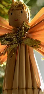 Rustic straw Christmas angel with golden wings.